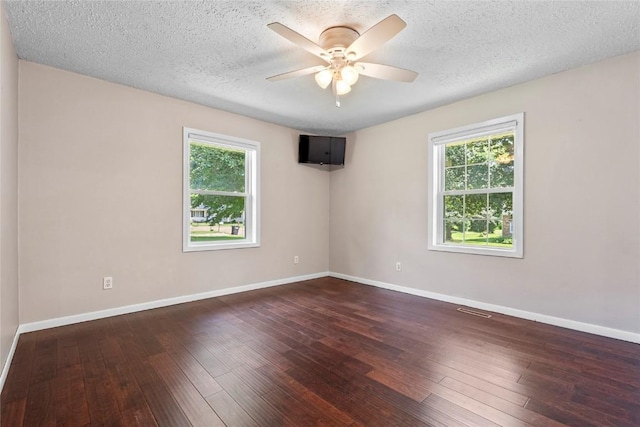 101 Golf Cir, Winfield, IA 52659 - unfurnished room with healthy amount of natural light, ceiling fan, wood-type flooring, and a textured ceiling