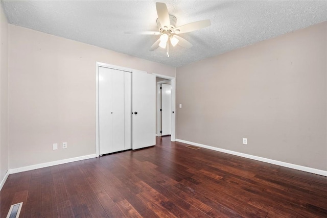 101 Golf Cir, Winfield, IA 52659 - unfurnished bedroom featuring wood-type flooring, a textured ceiling, a closet, and ceiling fan