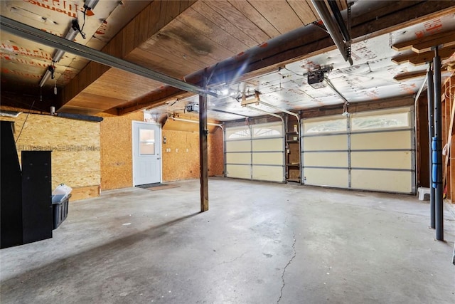 101 Golf Cir, Winfield, IA 52659 - garage featuring a garage door opener