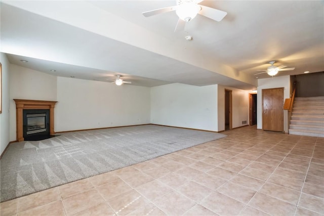 4118 Paradise Ct NW, Cedar Rapids, IA 52405 - unfurnished living room featuring a ceiling fan, stairway, and a fireplace with flush hearth