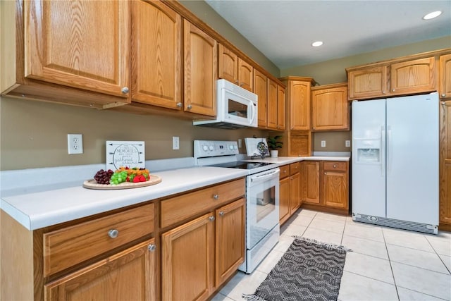 4118 Paradise Ct NW, Cedar Rapids, IA 52405 - kitchen featuring white appliances, light countertops, light tile patterned flooring, brown cabinets, and recessed lighting