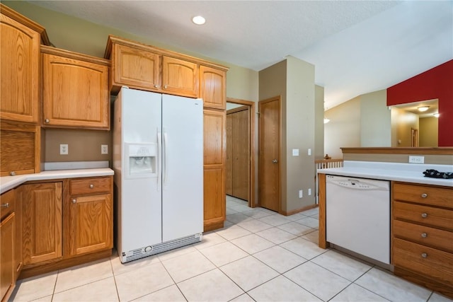 4118 Paradise Ct NW, Cedar Rapids, IA 52405 - kitchen with white appliances, light countertops, light tile patterned flooring, and brown cabinetry