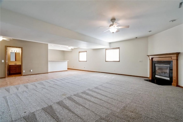 4118 Paradise Ct NW, Cedar Rapids, IA 52405 - unfurnished living room with a ceiling fan, a fireplace with flush hearth, and light colored carpet