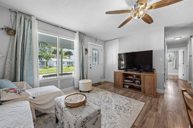 665 Hillview Dr, Marion, IA 52302 - living area featuring wood finished floors, a textured ceiling, and ceiling fan
