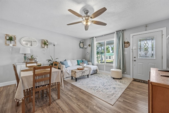 665 Hillview Dr, Marion, IA 52302 - dining space featuring ceiling fan, wood finished floors, and a textured ceiling