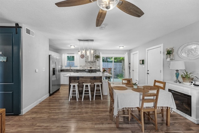 665 Hillview Dr, Marion, IA 52302 - dining room with dark wood finished floors, ceiling fan, and a textured ceiling