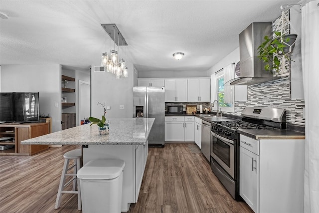 665 Hillview Dr, Marion, IA 52302 - kitchen featuring stainless steel appliances, extractor fan, a center island, tasteful backsplash, and white cabinets