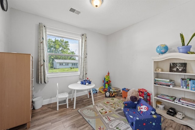 665 Hillview Dr, Marion, IA 52302 - playroom with wood finished floors and baseboards