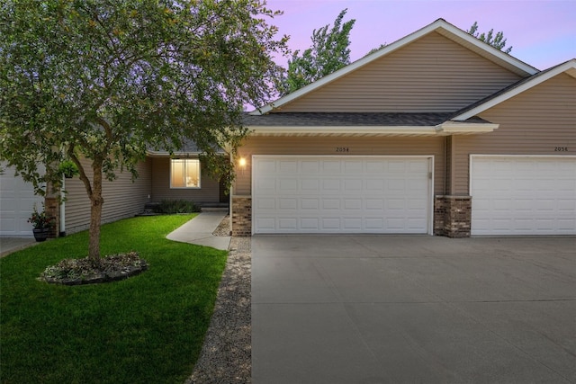 2054 Shortgrass Pl, Marion, IA 52302 - view of front of house featuring a lawn, an attached garage, driveway, and brick siding
