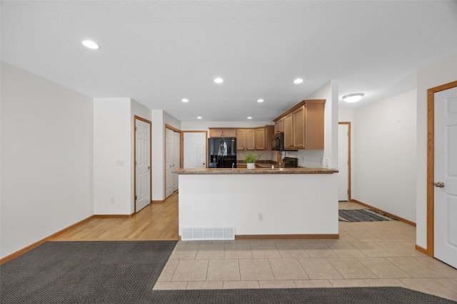 2054 Shortgrass Pl, Marion, IA 52302 - kitchen featuring black appliances, recessed lighting, a peninsula, brown cabinetry, and light tile patterned floors