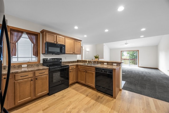 2054 Shortgrass Pl, Marion, IA 52302 - kitchen with black appliances, a peninsula, brown cabinets, recessed lighting, and open floor plan