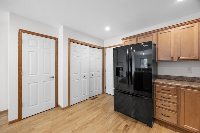 2054 Shortgrass Pl, Marion, IA 52302 - kitchen featuring black fridge, light wood-style floors, dark countertops, recessed lighting, and brown cabinets