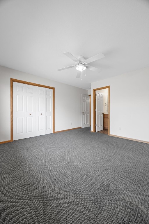 2054 Shortgrass Pl, Marion, IA 52302 - unfurnished bedroom with carpet floors, a closet, and ceiling fan