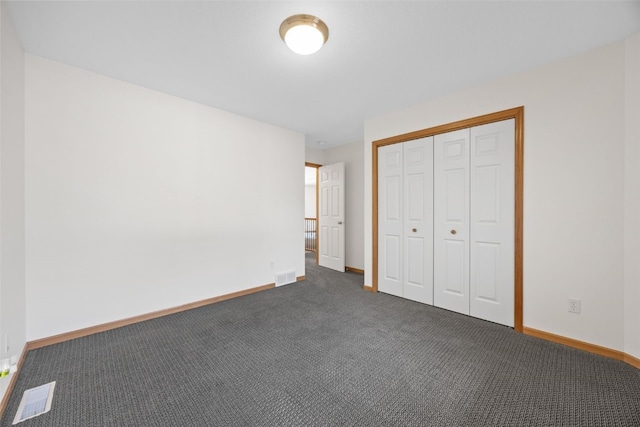 2054 Shortgrass Pl, Marion, IA 52302 - unfurnished bedroom with dark carpet and a closet