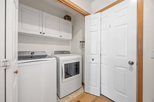 2054 Shortgrass Pl, Marion, IA 52302 - laundry area with cabinet space, washer and dryer, and light wood-style flooring