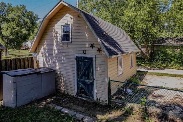 701 Hall Ave, Lowden, IA 52255 - rear view of property featuring a gambrel roof and an outbuilding