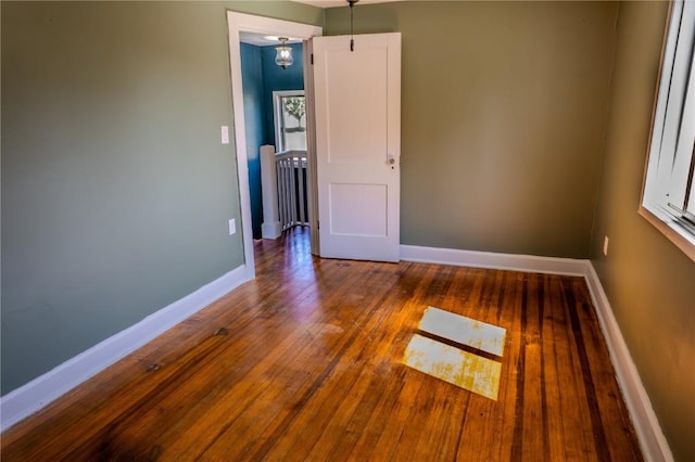 701 Hall Ave, Lowden, IA 52255 - empty room featuring wood-type flooring and baseboards