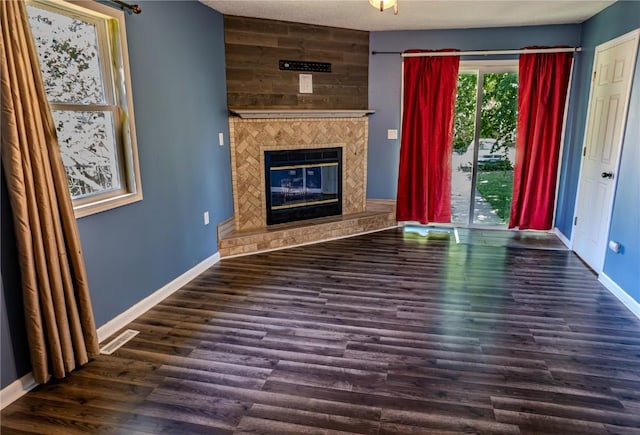 701 Hall Ave, Lowden, IA 52255 - unfurnished living room with a fireplace and wood finished floors