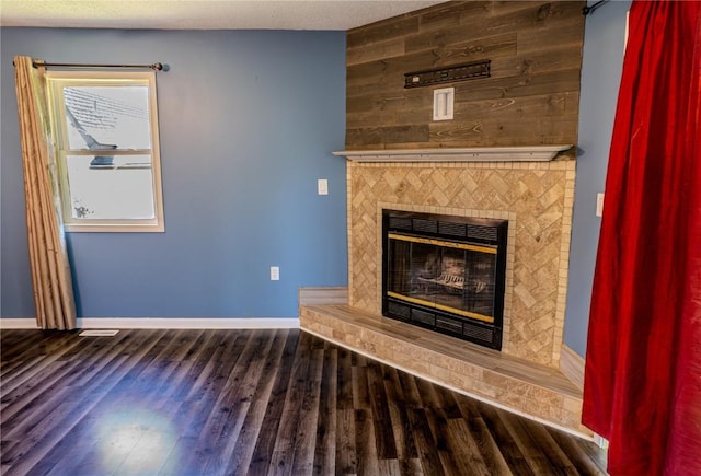 701 Hall Ave, Lowden, IA 52255 - unfurnished living room featuring a large fireplace and wood finished floors