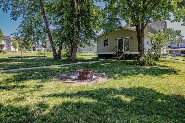 701 Hall Ave, Lowden, IA 52255 - fenced backyard with an outdoor fire pit and entry steps