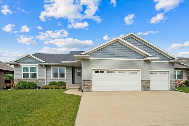 8313 Monterey Dr NE, Cedar Rapids, IA 52402 - craftsman inspired home with stone siding, concrete driveway, an attached garage, and a front yard