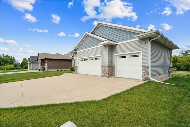 8313 Monterey Dr NE, Cedar Rapids, IA 52402 - view of home's exterior with a lawn, concrete driveway, stone siding, and an attached garage