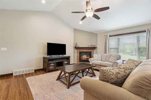 8313 Monterey Dr NE, Cedar Rapids, IA 52402 - living room featuring lofted ceiling, a ceiling fan, wood finished floors, a glass covered fireplace, and recessed lighting