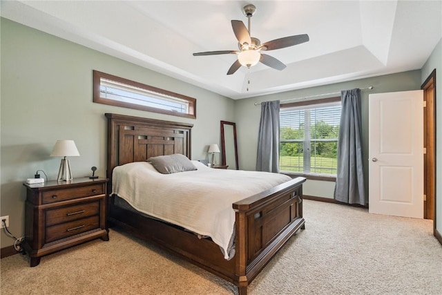 8313 Monterey Dr NE, Cedar Rapids, IA 52402 - bedroom featuring a tray ceiling, light colored carpet, and ceiling fan