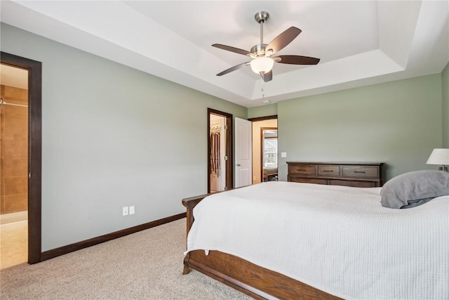 8313 Monterey Dr NE, Cedar Rapids, IA 52402 - bedroom featuring carpet floors, a tray ceiling, a spacious closet, a ceiling fan, and a closet
