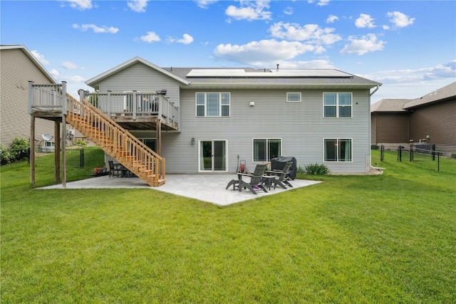 8313 Monterey Dr NE, Cedar Rapids, IA 52402 - rear view of property with stairs, a wooden deck, roof mounted solar panels, and a patio area