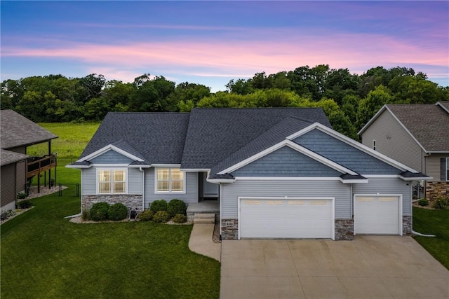 8313 Monterey Dr NE, Cedar Rapids, IA 52402 - view of front of home with stone siding, an attached garage, concrete driveway, and a front yard