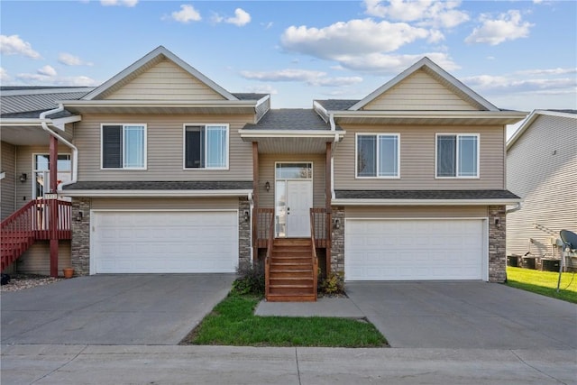 1810 Goose Lake Cir, North Liberty, IA 52317 - raised ranch featuring a garage, stone siding, and driveway