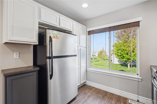 1810 Goose Lake Cir, North Liberty, IA 52317 - kitchen featuring freestanding refrigerator, wood finished floors, white cabinetry, and healthy amount of natural light