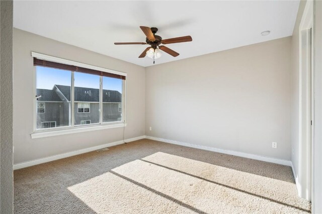1810 Goose Lake Cir, North Liberty, IA 52317 - carpeted spare room with baseboards and ceiling fan