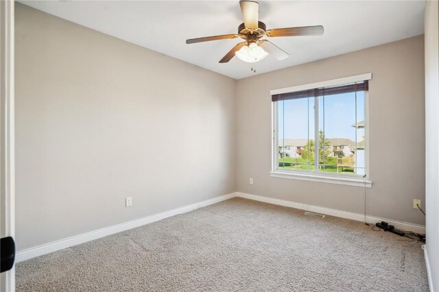 1810 Goose Lake Cir, North Liberty, IA 52317 - carpeted spare room featuring baseboards and a ceiling fan