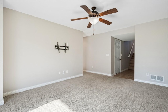 1810 Goose Lake Cir, North Liberty, IA 52317 - carpeted empty room with a ceiling fan and stairs