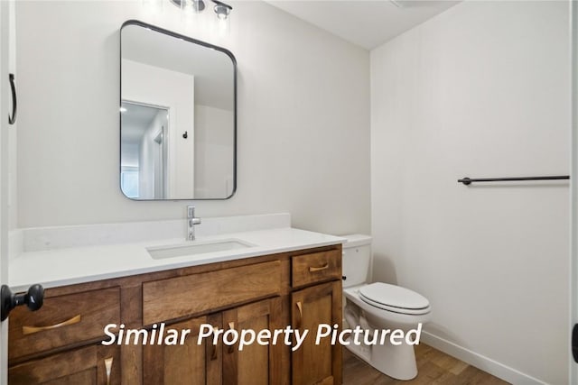 4620 Preston Ln, Iowa City, IA 52246 - half bathroom featuring vanity and wood finished floors