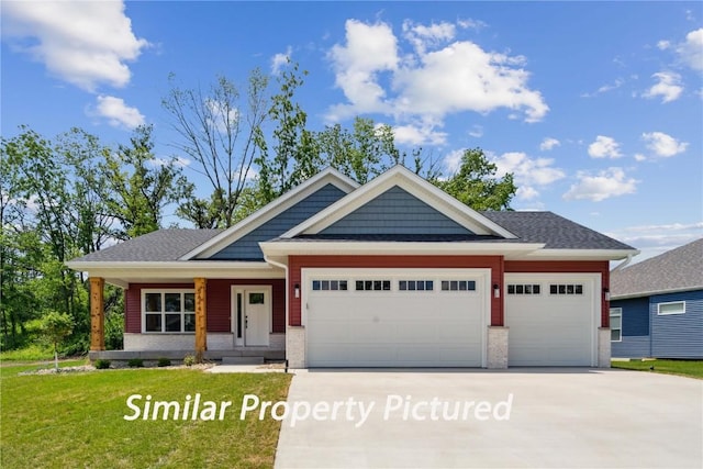 4620 Preston Ln, Iowa City, IA 52246 - view of front of home with a garage, concrete driveway, a front lawn, and brick siding