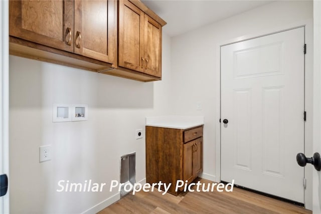 4620 Preston Ln, Iowa City, IA 52246 - washroom with cabinet space, washer hookup, wood finished floors, and hookup for an electric dryer