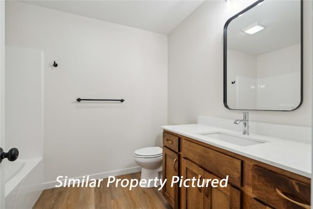 4620 Preston Ln, Iowa City, IA 52246 - bathroom with wood finished floors, vanity, and shower / bathtub combination
