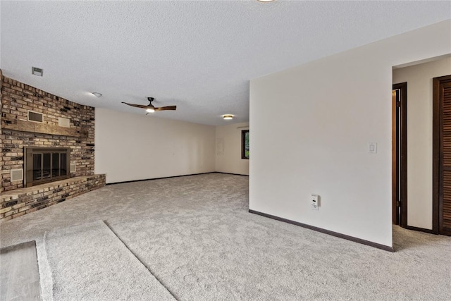 1131 Penkridge Dr, Iowa City, IA 52246 - unfurnished living room with carpet, ceiling fan, a fireplace, and a textured ceiling