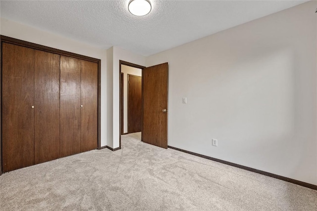 1131 Penkridge Dr, Iowa City, IA 52246 - unfurnished bedroom with carpet, a closet, and a textured ceiling