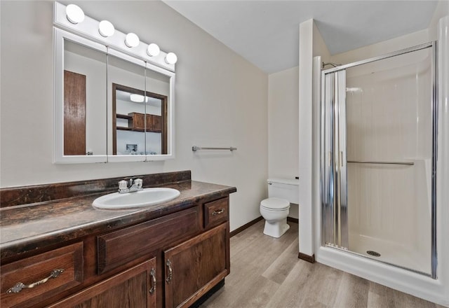 1131 Penkridge Dr, Iowa City, IA 52246 - bathroom featuring a stall shower, vanity, and wood finished floors