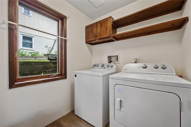 1131 Penkridge Dr, Iowa City, IA 52246 - laundry room with cabinet space, washer and dryer, healthy amount of natural light, and wood finished floors