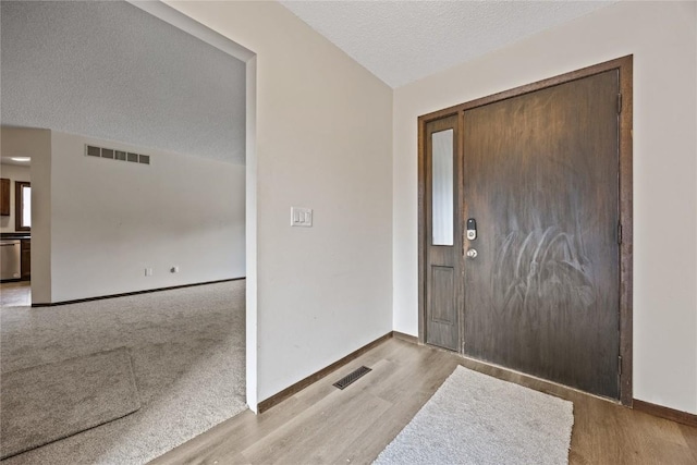 1131 Penkridge Dr, Iowa City, IA 52246 - foyer with a textured ceiling and wood finished floors
