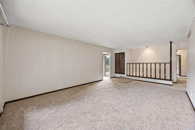 1131 Penkridge Dr, Iowa City, IA 52246 - spare room featuring light carpet and a textured ceiling