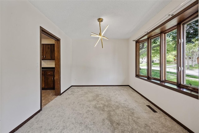 1131 Penkridge Dr, Iowa City, IA 52246 - spare room with light colored carpet and a textured ceiling