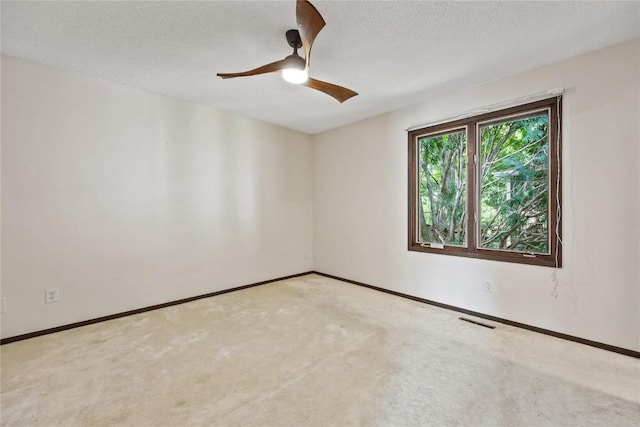 1131 Penkridge Dr, Iowa City, IA 52246 - unfurnished room with a ceiling fan, carpet flooring, and a textured ceiling