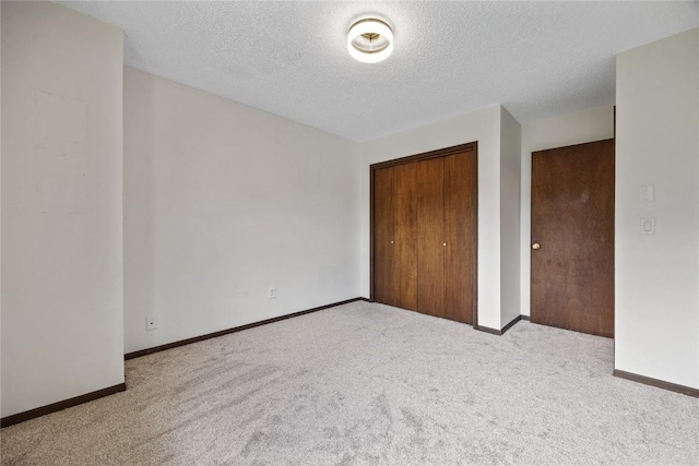 1131 Penkridge Dr, Iowa City, IA 52246 - unfurnished bedroom featuring carpet floors, a closet, and a textured ceiling