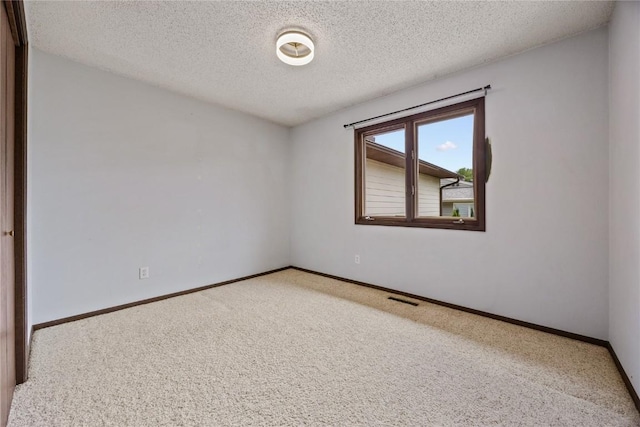 1131 Penkridge Dr, Iowa City, IA 52246 - spare room with carpet and a textured ceiling